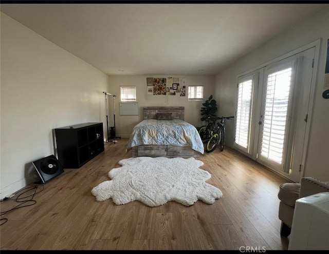 2145 Grand Ave, San Bernardino, CA 92407 - bedroom featuring access to exterior, wood finished floors, and baseboards