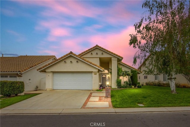 view of front of home featuring a tiled roof, a front lawn, stucco siding, driveway, and a garage