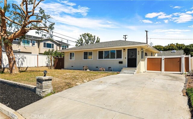 1361 Kenneth Dr, Tustin, CA 92780 - view of front facade featuring stucco siding, driveway, and a gate
