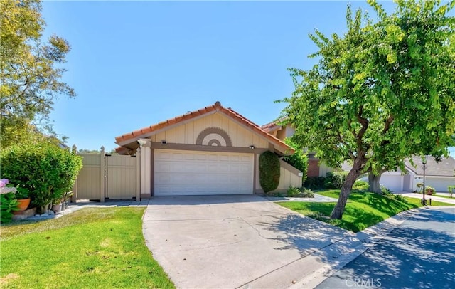 10 Mela Ln, Rancho Palos Verdes, CA 90275 - mediterranean / spanish home featuring a tiled roof, a gate, concrete driveway, an attached garage, and a front yard