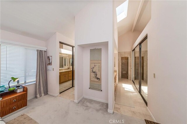 10 Mela Ln, Rancho Palos Verdes, CA 90275 - hall with vaulted ceiling with skylight, baseboards, and light carpet