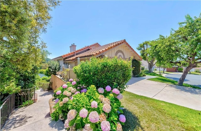 10 Mela Ln, Rancho Palos Verdes, CA 90275 - view of front of property featuring stucco siding, a tile roof, a chimney, and fence