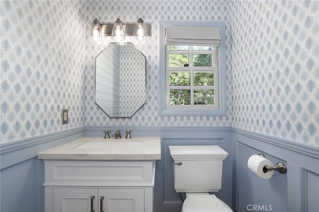 335 Sycamore Gln, Pasadena, CA 91105 - bathroom with wallpapered walls, toilet, a wainscoted wall, and vanity