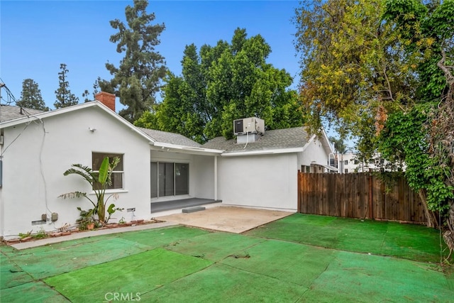 8856 Fullbright Ave, Winnetka, CA 91306 - rear view of house featuring fence, a shingled roof, stucco siding, and a patio