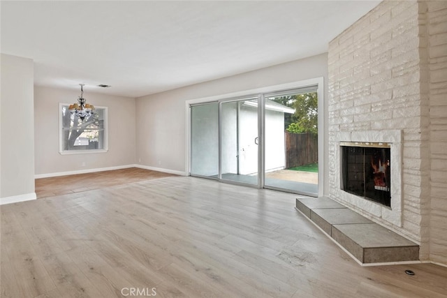 8856 Fullbright Ave, Winnetka, CA 91306 - unfurnished living room featuring wood finished floors, baseboards, a wealth of natural light, and a chandelier