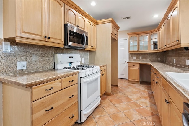 8856 Fullbright Ave, Winnetka, CA 91306 - kitchen with visible vents, light brown cabinets, white range with gas stovetop, and stainless steel microwave