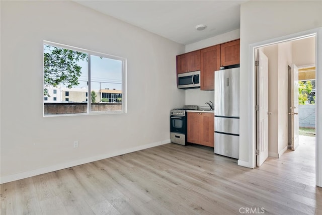 8856 Fullbright Ave, Winnetka, CA 91306 - kitchen featuring light wood finished floors, stainless steel appliances, and brown cabinets