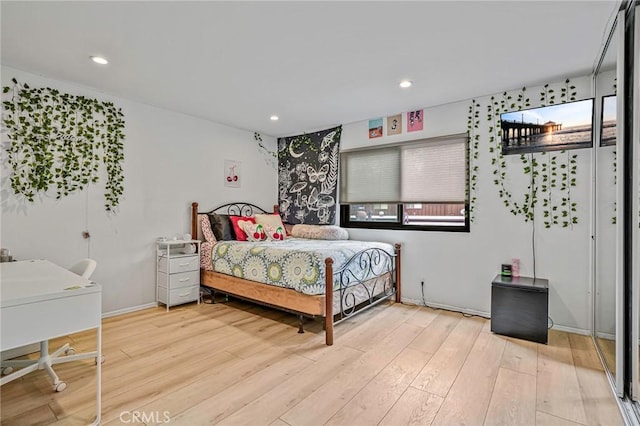 bedroom featuring baseboards, recessed lighting, and wood finished floors