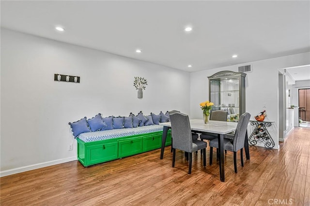 dining room with recessed lighting, baseboards, and wood finished floors