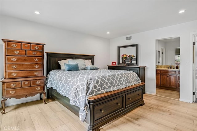 bedroom featuring recessed lighting, light wood finished floors, ensuite bath, and visible vents