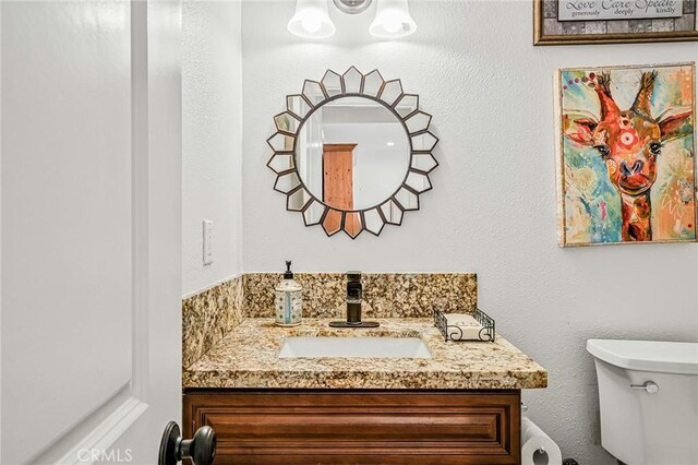 half bath with vanity and toilet