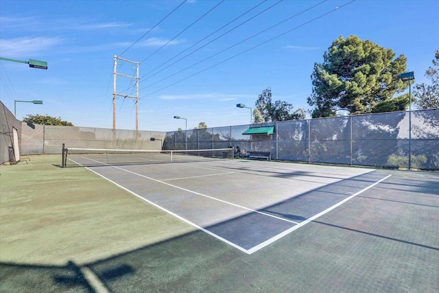 view of tennis court with fence