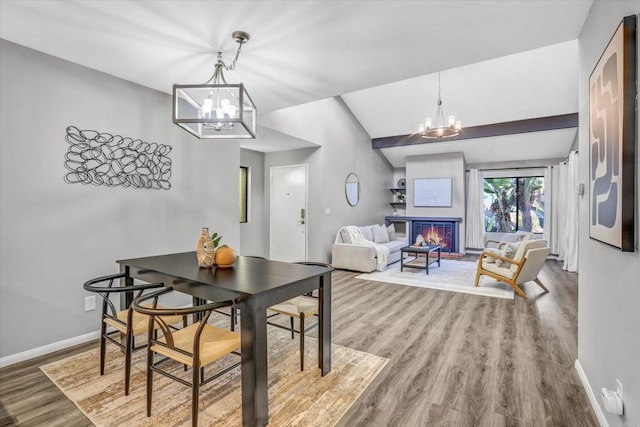 dining room with baseboards, wood finished floors, and a chandelier