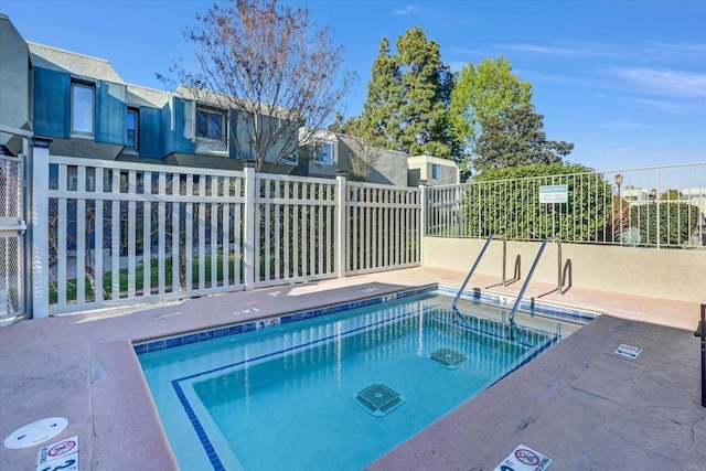 view of pool featuring fence