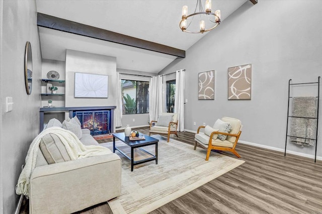living room with a chandelier, baseboards, lofted ceiling with beams, and wood finished floors