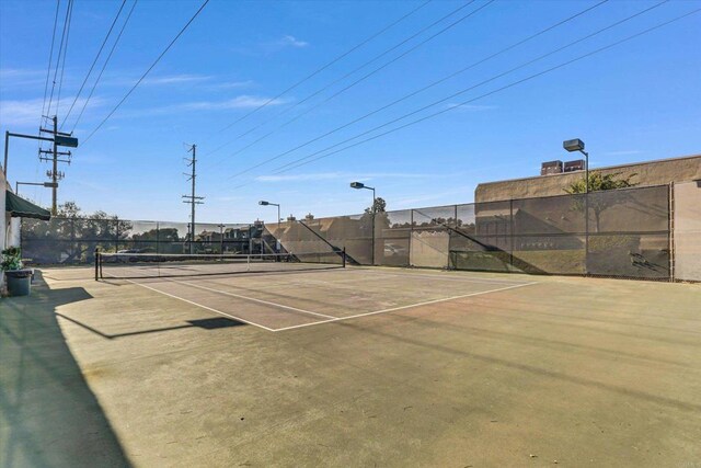 view of sport court with fence