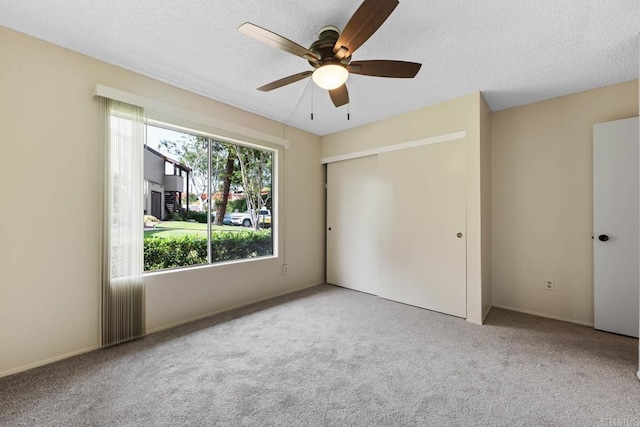 6560 College Grove Dr Unit 79, San Diego, CA 92115 - unfurnished bedroom with carpet floors, ceiling fan, a closet, and a textured ceiling