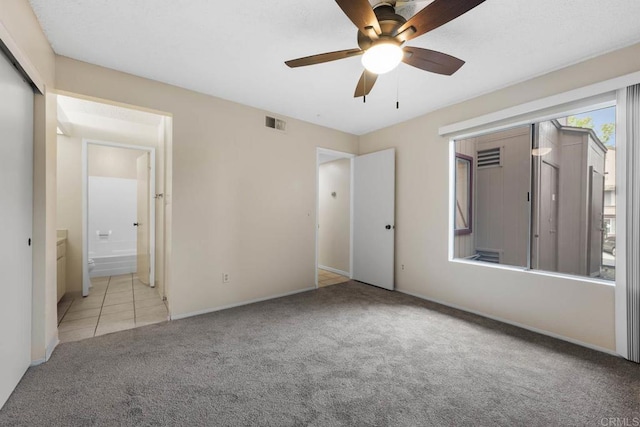 6560 College Grove Dr Unit 79, San Diego, CA 92115 - unfurnished bedroom with carpet floors, visible vents, baseboards, a ceiling fan, and ensuite bath