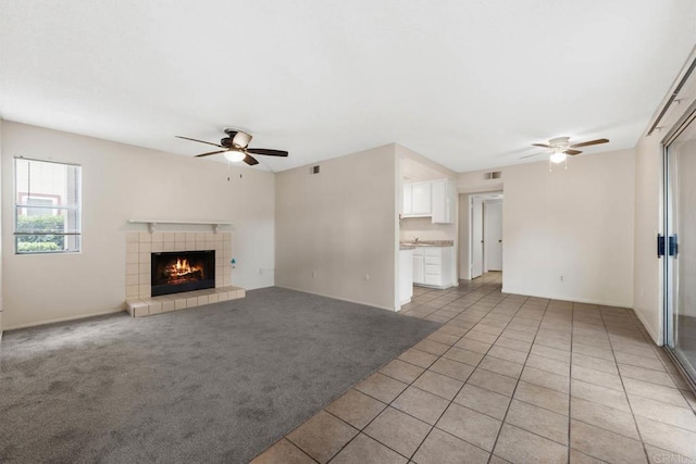6560 College Grove Dr Unit 79, San Diego, CA 92115 - unfurnished living room featuring ceiling fan, visible vents, a tiled fireplace, and light tile patterned floors