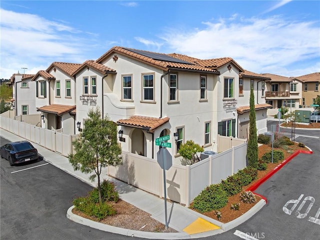 45477 Calle Cirros, Temecula, CA 92592 - view of front facade with a tiled roof, a residential view, solar panels, stucco siding, and uncovered parking