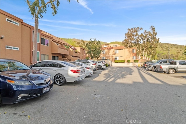 uncovered parking lot with a mountain view and a residential view