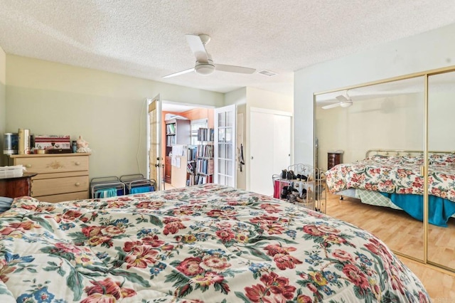 16407 Gabarda Rd, San Diego, CA 92128 - bedroom with wood finished floors, a textured ceiling, a ceiling fan, and a closet