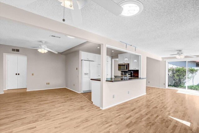 16407 Gabarda Rd, San Diego, CA 92128 - unfurnished living room with ceiling fan, a textured ceiling, and light wood-type flooring