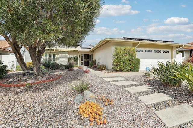 16407 Gabarda Rd, San Diego, CA 92128 - view of front of home with a garage, solar panels, and stucco siding