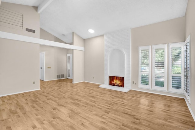 16407 Gabarda Rd, San Diego, CA 92128 - unfurnished living room featuring high vaulted ceiling, light wood-style flooring, a fireplace, and beam ceiling