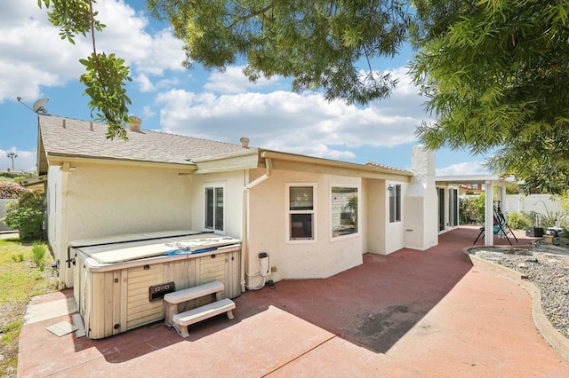 16407 Gabarda Rd, San Diego, CA 92128 - rear view of house with a hot tub, a patio area, and stucco siding