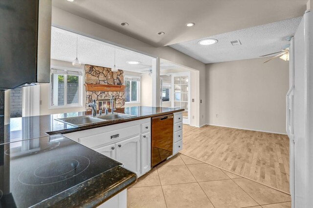 16407 Gabarda Rd, San Diego, CA 92128 - kitchen with dishwasher, a fireplace, dark countertops, black electric stovetop, and a textured ceiling