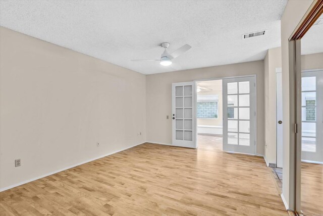 16407 Gabarda Rd, San Diego, CA 92128 - spare room featuring light wood finished floors, a textured ceiling, a ceiling fan, french doors, and healthy amount of natural light