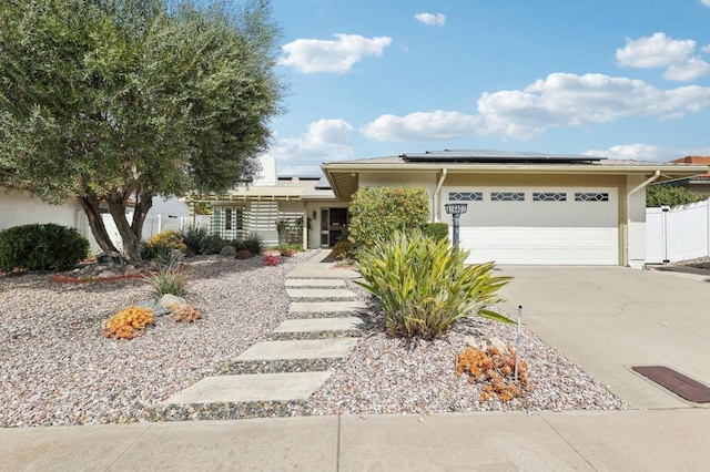 16407 Gabarda Rd, San Diego, CA 92128 - view of front of house featuring a garage, concrete driveway, stucco siding, and solar panels