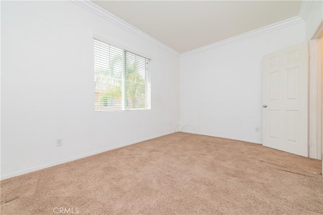 unfurnished room with baseboards, ornamental molding, and carpet