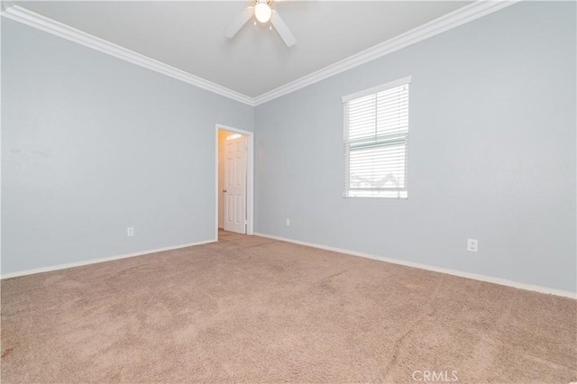 carpeted empty room featuring ceiling fan, baseboards, and ornamental molding