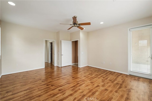 empty room featuring baseboards, a ceiling fan, light wood-style flooring, and recessed lighting