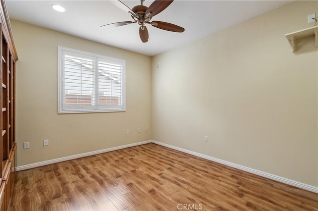spare room featuring baseboards, recessed lighting, ceiling fan, and wood finished floors