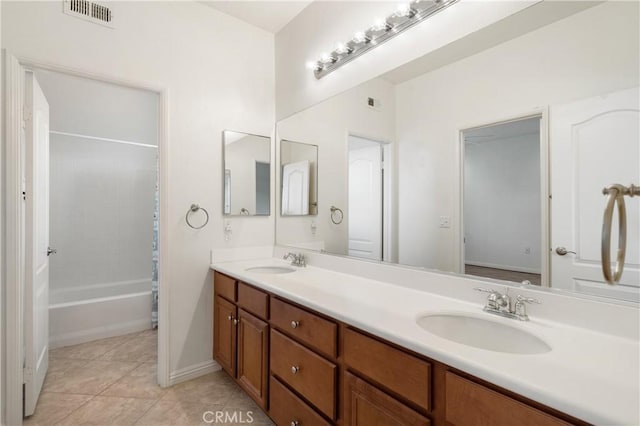 bathroom with visible vents, a sink, tile patterned floors, and double vanity