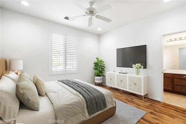 bedroom with visible vents, light wood-style floors, recessed lighting, connected bathroom, and a ceiling fan