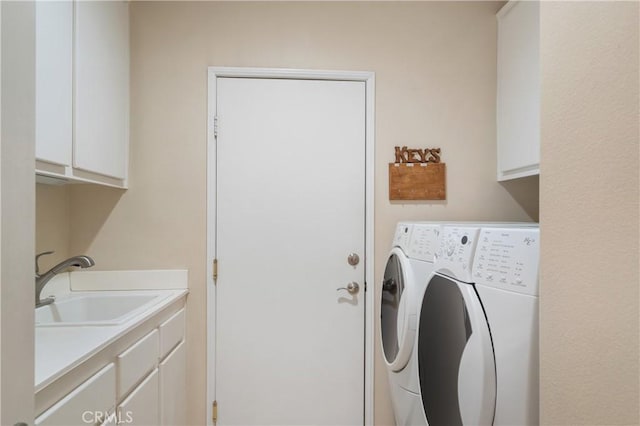laundry room featuring a sink, cabinet space, and washer and clothes dryer