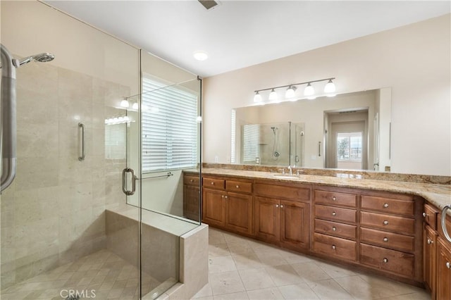 full bathroom with vanity, a shower stall, and tile patterned floors