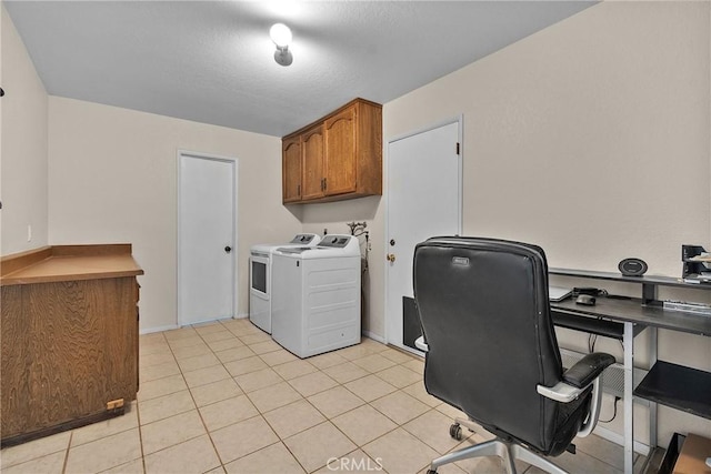 laundry area featuring separate washer and dryer, light tile patterned flooring, baseboards, and cabinet space