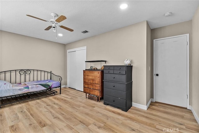 bedroom featuring light wood-style floors, baseboards, and visible vents