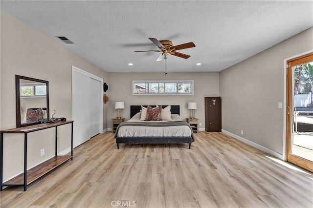 bedroom with baseboards, recessed lighting, light wood-style flooring, a textured ceiling, and visible vents