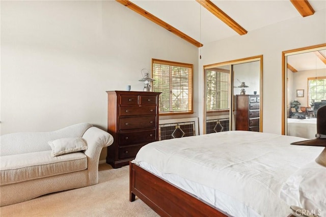 bedroom featuring multiple closets, vaulted ceiling with beams, and carpet floors