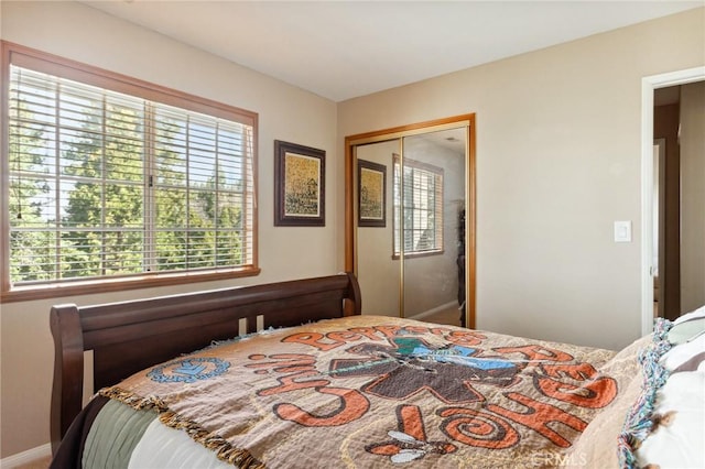 bedroom featuring a closet and baseboards