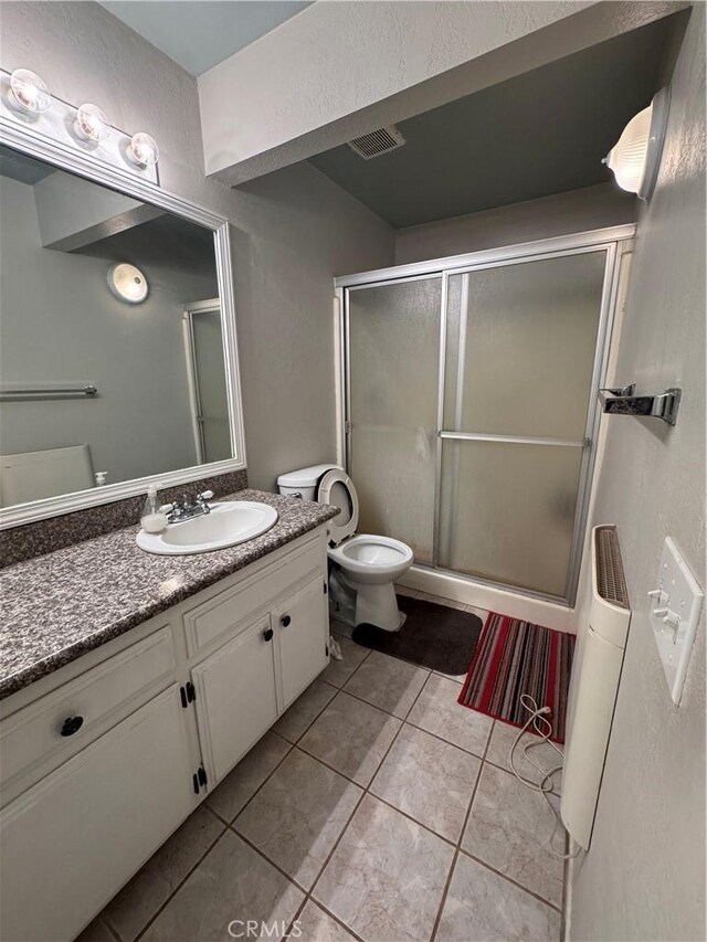 17665 Juniper St, Hesperia, CA 92345 - bathroom with a shower stall, vanity, tile patterned flooring, visible vents, and toilet