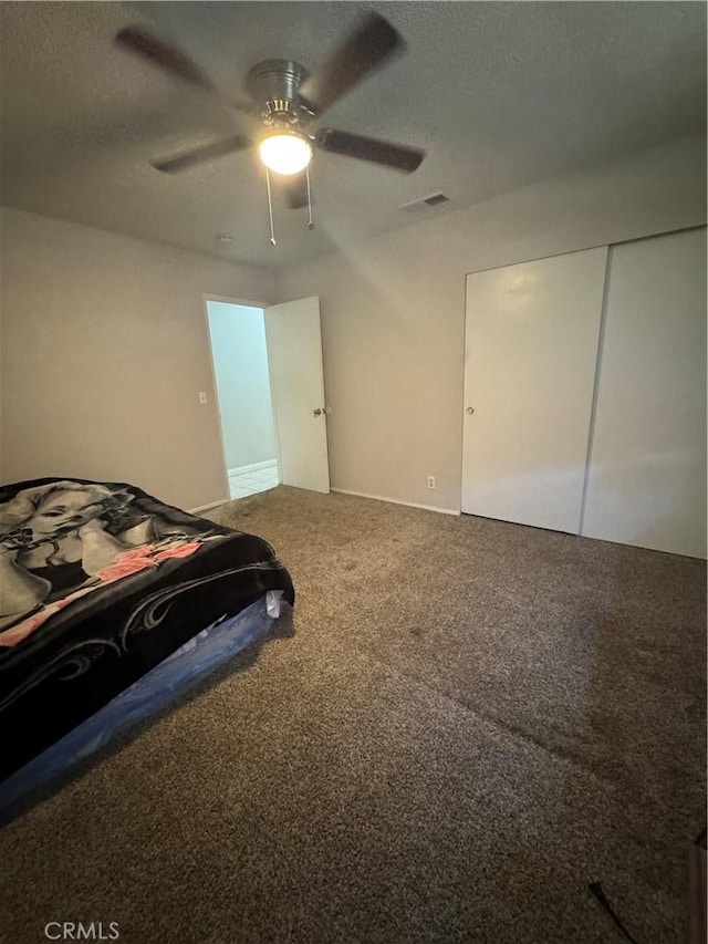 17665 Juniper St, Hesperia, CA 92345 - carpeted bedroom with a closet, visible vents, a textured ceiling, and ceiling fan