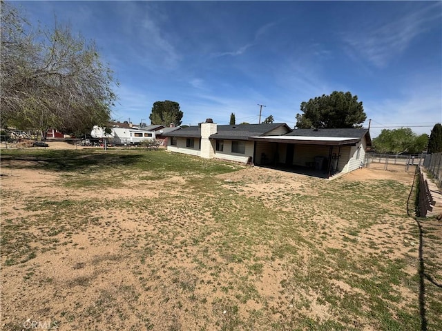 17665 Juniper St, Hesperia, CA 92345 - rear view of house featuring fence and a lawn