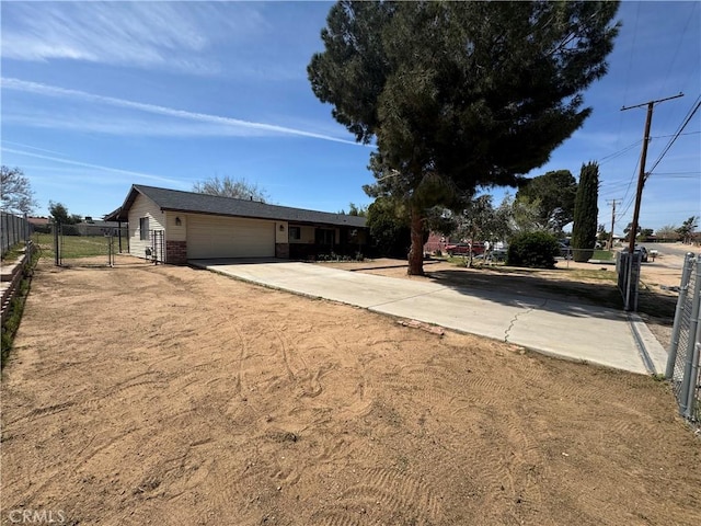 17665 Juniper St, Hesperia, CA 92345 - ranch-style house with concrete driveway, fence, and a garage